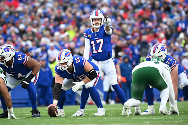 Buffalo Bills quarterback Josh Allen and OL Connor McGovern at the line of scrimmage.