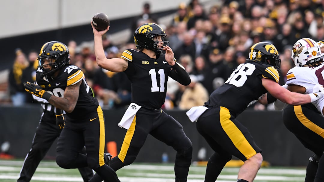 Oct 25, 2025; Iowa City, Iowa, USA; Iowa Hawkeyes quarterback Mark Gronowski (11) throws a pass during the first quarter against the Minnesota Golden Gophers at Kinnick Stadium. Mandatory Credit: Jeffrey Becker-Imagn Images