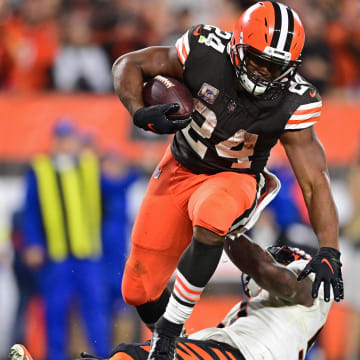 Oct 31, 2022; Cleveland, Ohio, USA; Cleveland Browns running back Nick Chubb (24) steps over Cincinnati Bengals linebacker Germaine Pratt (57) after scoring a touchdown in the fourth quarter at FirstEnergy Stadium.