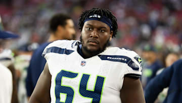 Dec 8, 2024; Glendale, Arizona, USA; Seattle Seahawks guard Christian Haynes (64) against the Arizona Cardinals at State Farm Stadium. Mandatory Credit: Mark J. Rebilas-Imagn Images