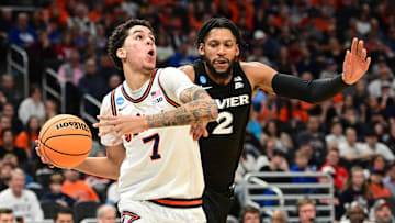Mar 21, 2025; Milwaukee, WI, USA: Illinois Fighting Illini forward Will Riley (7) drives to the hoop past Xavier Musketeers forward Jerome Hunter (2) during the second half at Fiserv Forum. Mandatory Credit: Benny Sieu-Imagn Images
