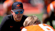 Oklahoma State Interim Head Coach/Offensive Coordinator Doug Meacham talks with Zane Flores (6) before the college football game between the Oklahoma State Cowboys and the Baylor Bears at Boone Pickens Stadium in Stillwater, Okla., Saturday, Sept. 27, 2025.