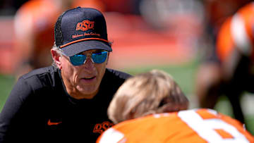 Oklahoma State Interim Head Coach/Offensive Coordinator Doug Meacham talks with Zane Flores (6) before the college football game between the Oklahoma State Cowboys and the Baylor Bears at Boone Pickens Stadium in Stillwater, Okla., Saturday, Sept. 27, 2025.