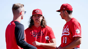 Cincinnati Reds pitcher Rhett Lowder (25), center, has a conversation with a staff member, left, and non-roster invitee Chase Burns (81) after a pitching session during spring training, Friday, Feb. 21, 2025, at the Cincinnati Reds Player Development Complex in Goodyear, Ariz.