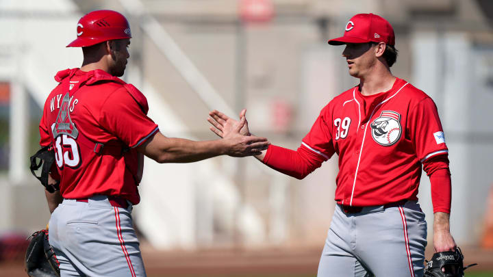 Cincinnati Reds non-roster invitee catcher Austin Wynns shakes hands with pitcher Lucas Sims at the conclusion of a live batting practice session, Sunday, Feb. 18, 2024, at the team's spring training facility in Goodyear, Ariz.