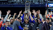 Oct 31, 2024; New York, New York, USA; Los Angeles Dodgers shortstop Mookie Betts (50) celebrates with the Commissioner’s Trophy after the Los Angeles Dodgers beat the New York Yankees in game four to win the 2024 MLB World Series at Yankee Stadium. 