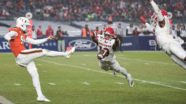 Rutgers Scarlet Knights defensive back Todd Bowles Jr. (19) blocks a punt by Miami Hurricanes punter Dylan Joyce (94) 