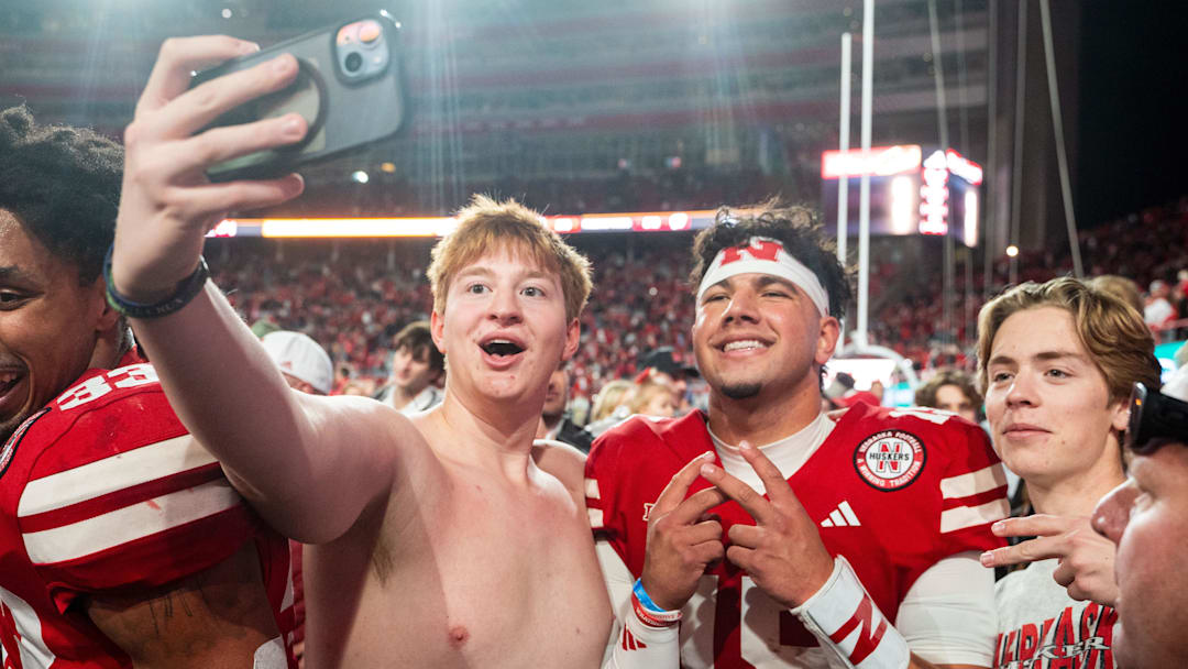 Nov 23, 2024; Lincoln, Nebraska, USA; Nebraska Cornhuskers quarterback Dylan Raiola (15) takes a picture with fans after defeating the Wisconsin Badgers at Memorial Stadium. Nov 23, 2024; Lincoln, Nebraska, USA; Nebraska Cornhuskers quarterback Dylan Raiola (15) takes a picture with fans after defeating the Wisconsin Badgers at Memorial Stadium.