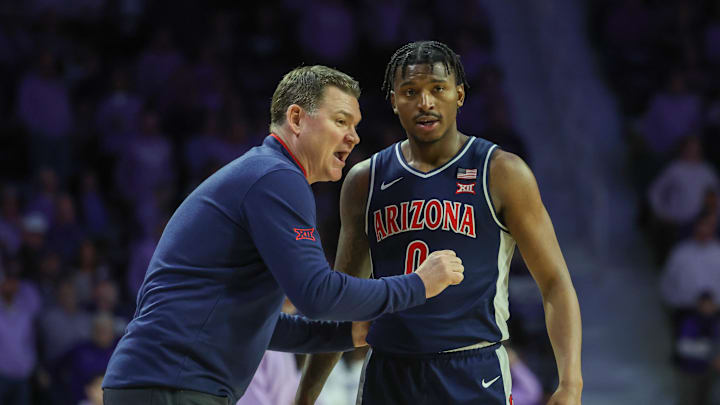 Feb 11, 2025; Manhattan, Kansas, USA; Arizona Wildcats head coach Tommy Lloyd talks to guard Jaden Bradley (0) during a timeout in the second half against the Kansas State Wildcats at Bramlage Coliseum. Mandatory Credit: Scott Sewell-Imagn Images