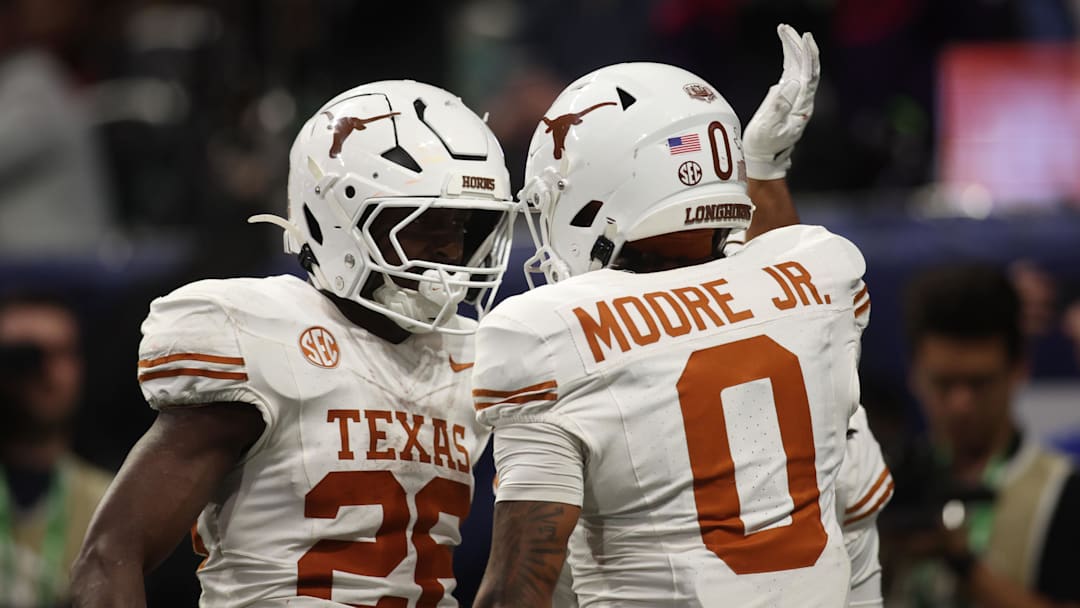 Dec 7, 2024; Atlanta, GA, USA; Texas Longhorns wide receiver DeAndre Moore Jr. (0) reacts after making a touchdown catch against the Georgia Bulldogs during the second half in the 2024 SEC Championship game at Mercedes-Benz Stadium. Mandatory Credit: Brett Davis-Imagn Images