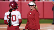 Oklahoma coach Patty Gasso speaks with second baseman Ailana Agbayani.
