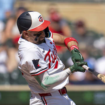 Sep 15, 2024; Minneapolis, Minnesota, USA; Minnesota Twins third baseman Royce Lewis (23) hits a single against the Cincinnati Reds in the fourth inning at Target Field. Mandatory Credit: Jesse Johnson-Imagn Images