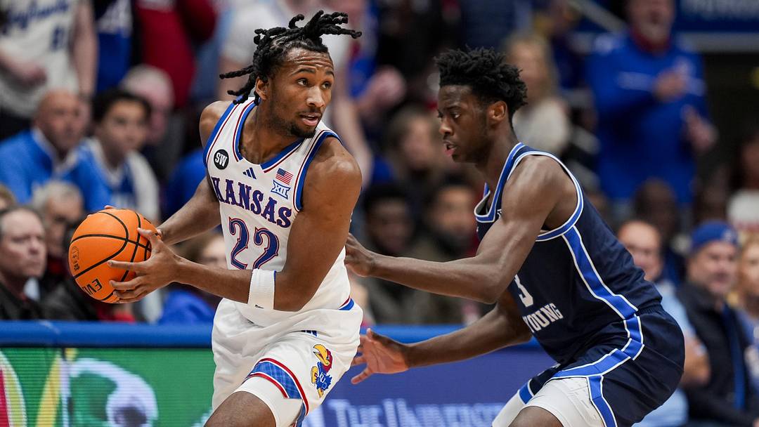 Jan 24, 2026; Columbia, Missouri, USA; Kansas Jayhawks guard Darryn Peterson (22) looks to pass against BYU Cougars forward AJ Dybantsa (3) during the first half at Mizzou Arena. Mandatory Credit: Jay Biggerstaff-Imagn Images