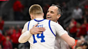 Mar 9, 2025; St. Louis, Missouri, USA;  Drake Bulldogs head coach Ben McCollum hugs guard Bennett Stirtz (14) after defeating the Bradley Braves to win the Missouri Valley Conference Tournament Championship at Enterprise Center. Mandatory Credit: Jeff Curry-Imagn Images
