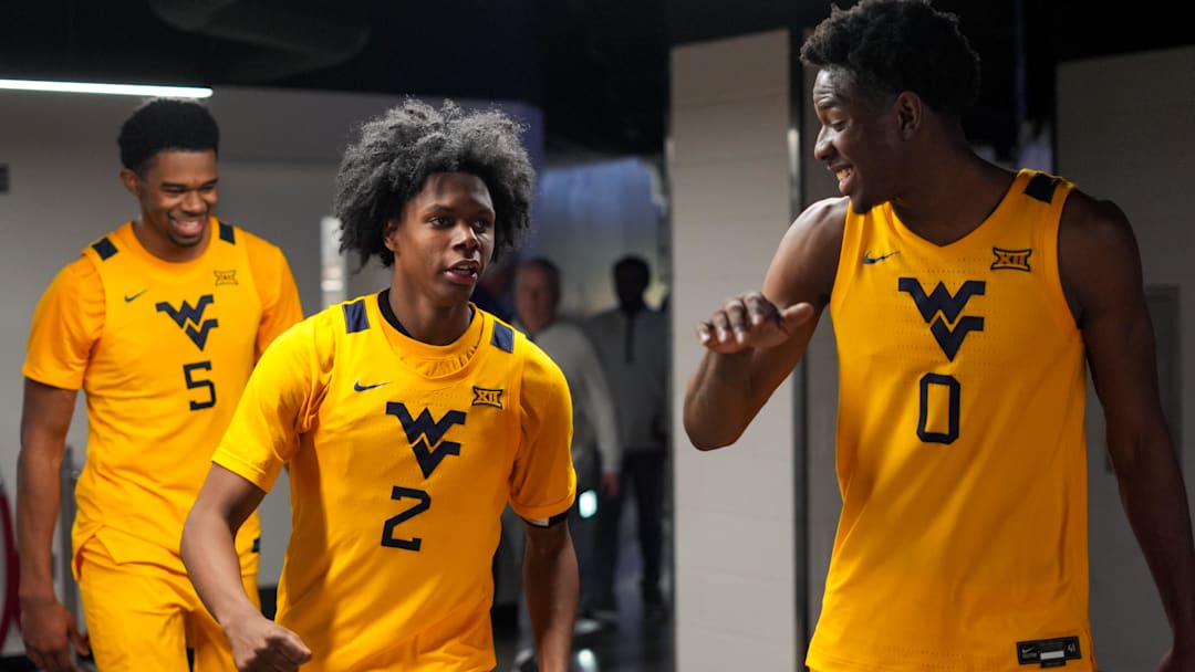 Feb 5, 2026; Cincinnati, Ohio, USA; West Virginia Mountaineers guard Amir Jenkins (2) and forward Brenen Lorient (0) celebrate after their team’s win against the Cincinnati Bearcats at Fifth Third Arena. Mandatory Credit: Aaron Doster-Imagn Images