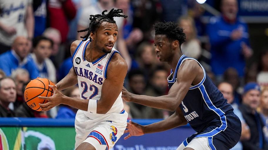 Kansas Jayhawks guard Darryn Peterson looks to pass against BYU Cougars forward AJ Dybantsa.