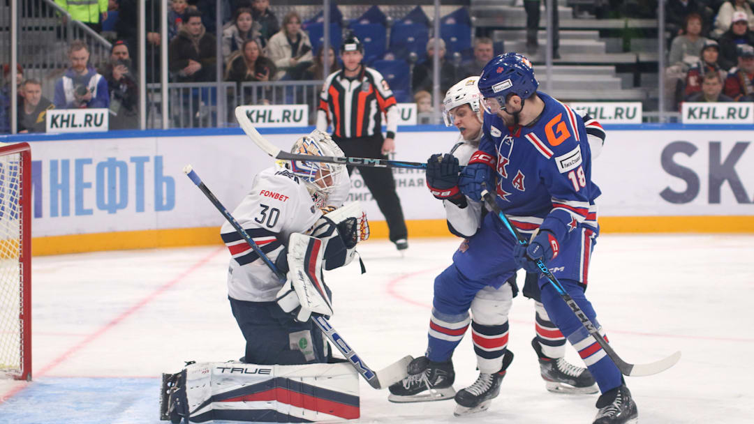 Ilya Nabokov (30) of Metallurg and Pavel Akolzin (18) of SKA...