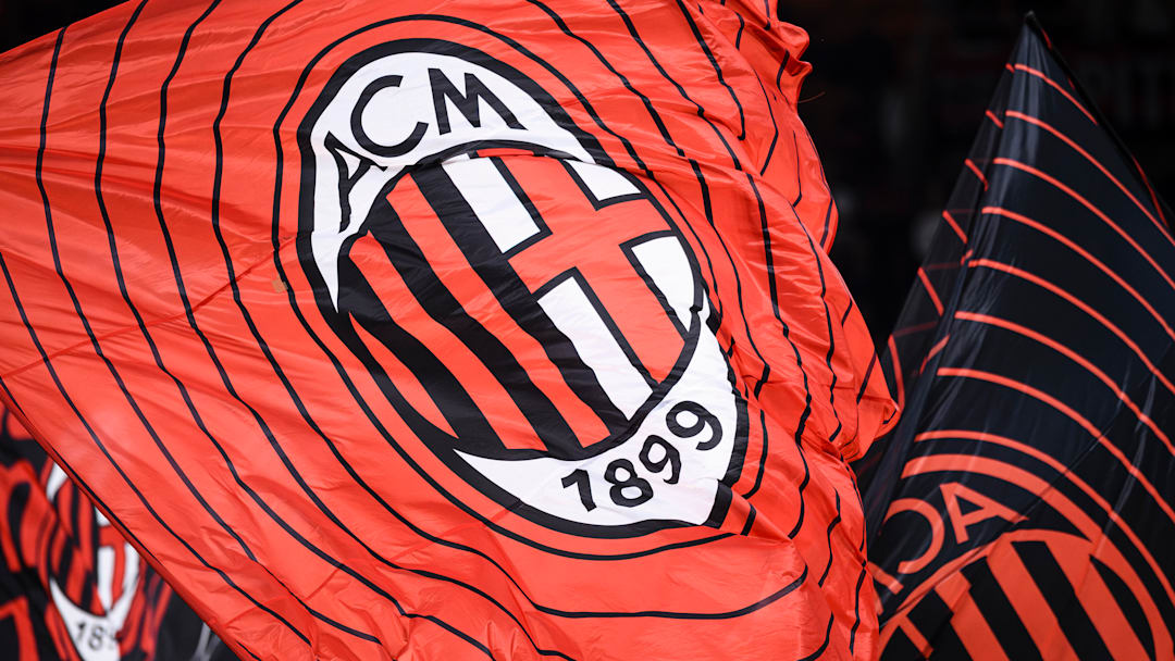 A flag bearing the crest of AC Milan is waved during the...