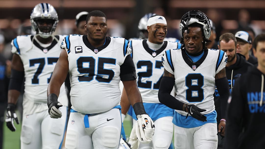 Dec 14, 2025; New Orleans, Louisiana, USA; Carolina Panthers defensive end Derrick Brown (95) and cornerback Jaycee Horn (8) walk on the field before the game against the New Orleans Saints at Caesars Superdome. Mandatory Credit: Stephen Lew-Imagn Images