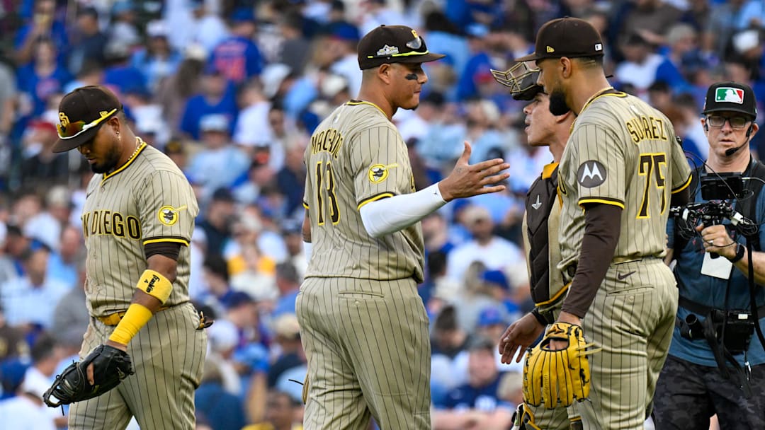 Oct 1, 2025; Chicago, Illinois, USA; San Diego Padres relief pitcher Robert Suarez (75) celebrates with teammates after the final out for the win against the Chicago Cubs in the ninth inning during game two of the Wildcard round for the 2025 MLB playoffs at Wrigley Field. Mandatory Credit: Matt Marton-Imagn Images