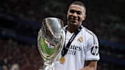 Kylian Mbappe of Real Madrid CF poses with the trophy during...