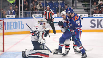 Ilya Nabokov (30) of Metallurg and Pavel Akolzin (18) of SKA...