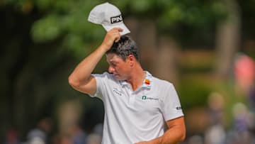 Viktor Hovland wipes off sweat at the Tour Championship at East Lake Golf Club in Atlanta, Georgia