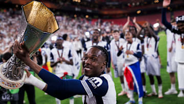 Mathys Tel of Tottenham Hotspur FC lifts the trophy during...