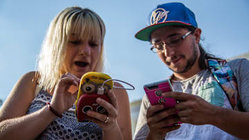A couple playing with their phones during a Pokemon Go...
