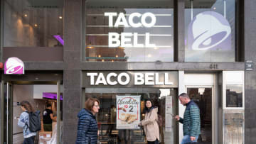 Pedestrians walk past the American chain of fast-food...