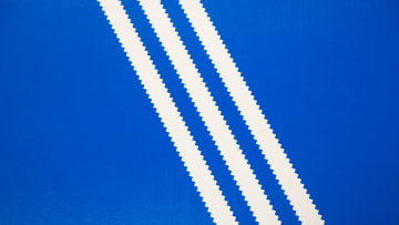 Old Adidas logo: Three white stripes on a blue background,...