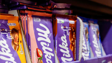 Milka chocolates are seen on a shop shelve. The chocolate...