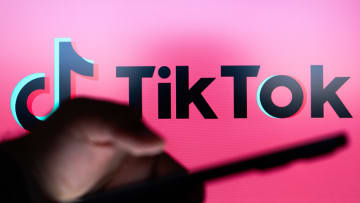 In this photo illustration the TikTok logo seen in the...