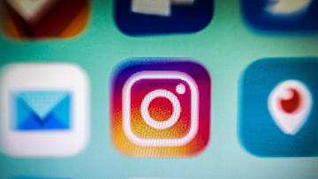 In this photo illustration, an Instagram app icon is...