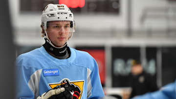 A Wilkes-Barre Penguins player #84 Clay Hanus wears a neck...