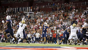 Oct 1, 2022; Tucson, Arizona, USA; Arizona Wildcats quarterback Jayden de Laura (7) throws a touchdown pass in the second half against the Colorado Buffaloes at Arizona Stadium. Mandatory Credit: Ivan Pierre Aguirre-Imagn Images