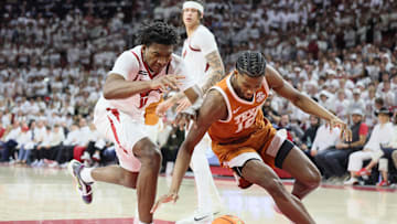 Feb 26, 2025; Fayetteville, Arkansas, USA; Texas Longhorns guard Tramon Mark (12) loses his dribble as Arkansas Razorbacks forward Karter Knox (11) defends during the second half at Bud Walton Arena. Mandatory Credit: Nelson Chenault-Imagn Images