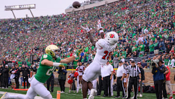 Sep 28, 2024; South Bend, Indiana, USA; Louisville Cardinals running back Isaac Brown (25) catches a pass for a touchdown against Notre Dame Fighting Irish linebacker Jack Kiser (24) in the first quarter at Notre Dame Stadium. Mandatory Credit: Matt Cashore-Imagn Images
