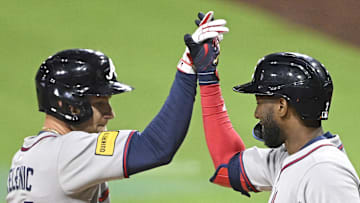Mar 28, 2025; San Diego, California, USA; Atlanta Braves left fielder Jarred Kelenic (24), left, is congratulated by  Jurickson Profar (7) after hitting a solo home run during fifth inning against the San Diego Padres at Petco Park. Mandatory Credit: Denis Poroy-Imagn Images