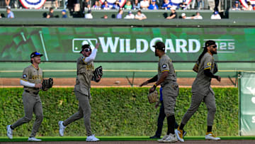 Oct 1, 2025; Chicago, Illinois, USA; San Diego Padres outfielders celebrate after the final out for the win against the Chicago Cubs in the ninth inning during game two of the Wildcard round for the 2025 MLB playoffs at Wrigley Field. Mandatory Credit: Matt Marton-Imagn Images