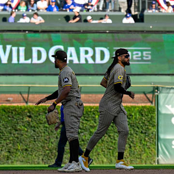 Oct 1, 2025; Chicago, Illinois, USA; San Diego Padres outfielders celebrate after the final out for the win against the Chicago Cubs in the ninth inning during game two of the Wildcard round for the 2025 MLB playoffs at Wrigley Field. Mandatory Credit: Matt Marton-Imagn Images