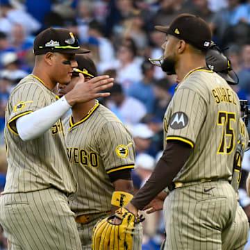 Oct 1, 2025; Chicago, Illinois, USA; San Diego Padres relief pitcher Robert Suarez (75) celebrates with teammates after the final out for the win against the Chicago Cubs in the ninth inning during game two of the Wildcard round for the 2025 MLB playoffs at Wrigley Field. Mandatory Credit: Matt Marton-Imagn Images