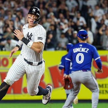 Oct 7, 2025; Bronx, New York, USA; New York Yankees outfielder Aaron Judge (99) rounds the bases after a double hit by Cody Bellinger (35) (not pictured) in the sixth inning against the Toronto Blue Jays during game three of the ALDS round for the 2025 MLB playoffs at Yankee Stadium. Mandatory Credit: Vincent Carchietta-Imagn Images