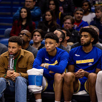 Nov 21, 2022; New Orleans, Louisiana, USA;  Golden State Warriors forward Anthony Lamb (40) and guard Ryan Rollins (2) and forward Anthony Lamb (40) and forward Patrick Baldwin Jr. (7) looks on from the bench against the New Orleans Pelicans during the second half at Smoothie King Center. Mandatory Credit: Stephen Lew-Imagn Images