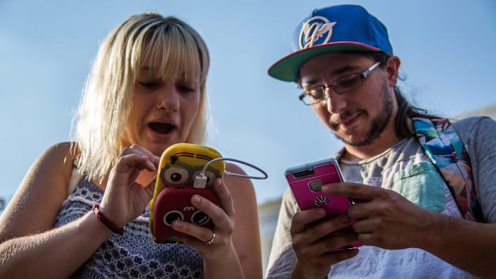 A couple playing with their phones during a Pokemon Go...