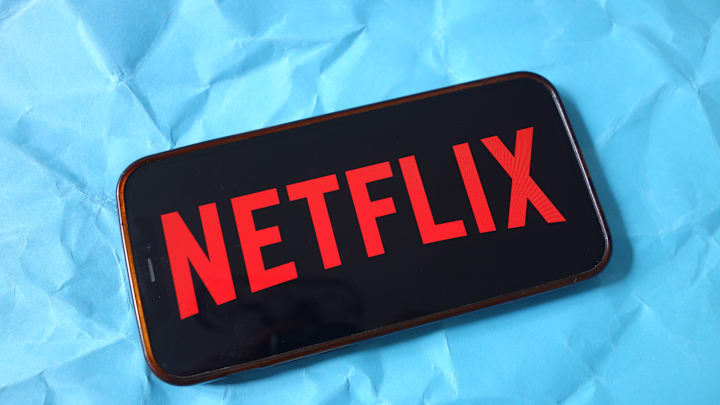 In this photo illustration, the Netflix company logo is seen...