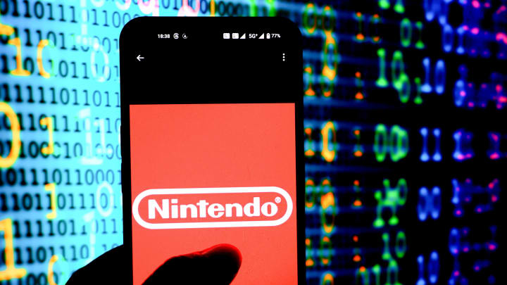 In this photo illustration, a Nintendo logo seen displayed...