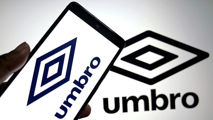 In this photo illustration, an Umbro Logo is seen displayed... In this photo illustration, an Umbro Logo is seen displayed...