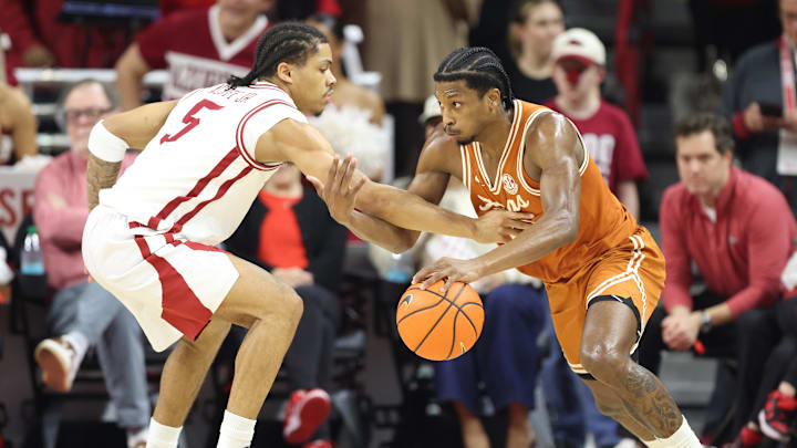 Mar 4, 2026; Fayetteville, Arkansas, USA; Arkansas Razorbacks guard Darius Acuff Jr (5) defends against Texas Longhorns guard Tramon Mark (12) during the first half at Bud Walton Arena. Arkansas won 105-85. Mandatory Credit: Nelson Chenault-Imagn Images