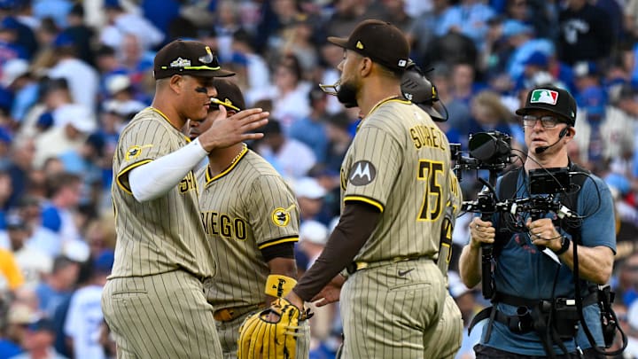 Oct 1, 2025; Chicago, Illinois, USA; San Diego Padres relief pitcher Robert Suarez (75) celebrates with teammates after the final out for the win against the Chicago Cubs in the ninth inning during game two of the Wildcard round for the 2025 MLB playoffs at Wrigley Field. Mandatory Credit: Matt Marton-Imagn Images Oct 1, 2025; Chicago, Illinois, USA; San Diego Padres relief pitcher Robert Suarez (75) celebrates with teammates after the final out for the win against the Chicago Cubs in the ninth inning during game two of the Wildcard round for the 2025 MLB playoffs at Wrigley Field. Mandatory Credit: Matt Marton-Imagn Images